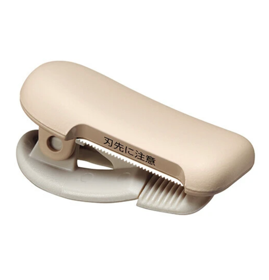 Beige washi tape cutter on a white background