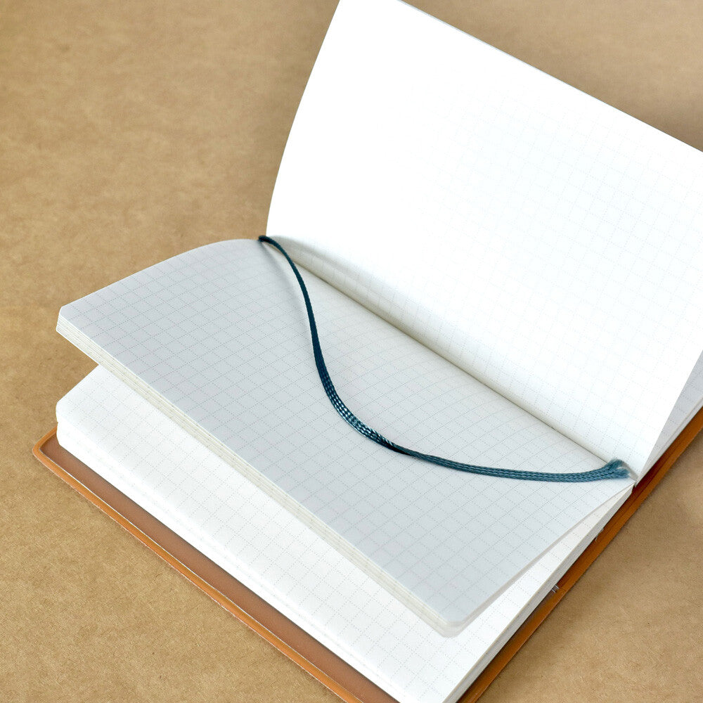 Open grid lined notebook on natural paper background