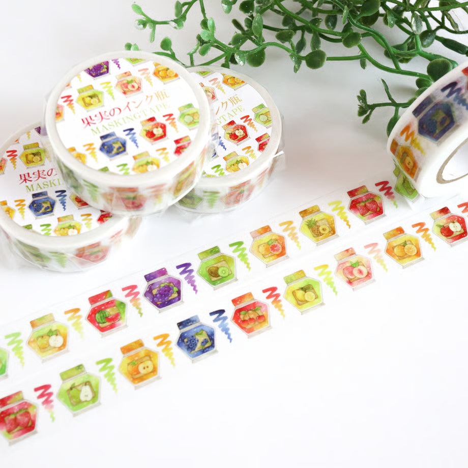 Decorative tape with colorful designs on a white surface with greenery in the background