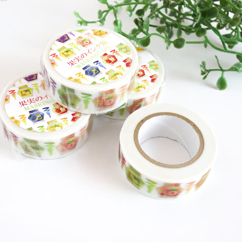 Decorative tape with colorful designs on a white surface with a plant in the background
