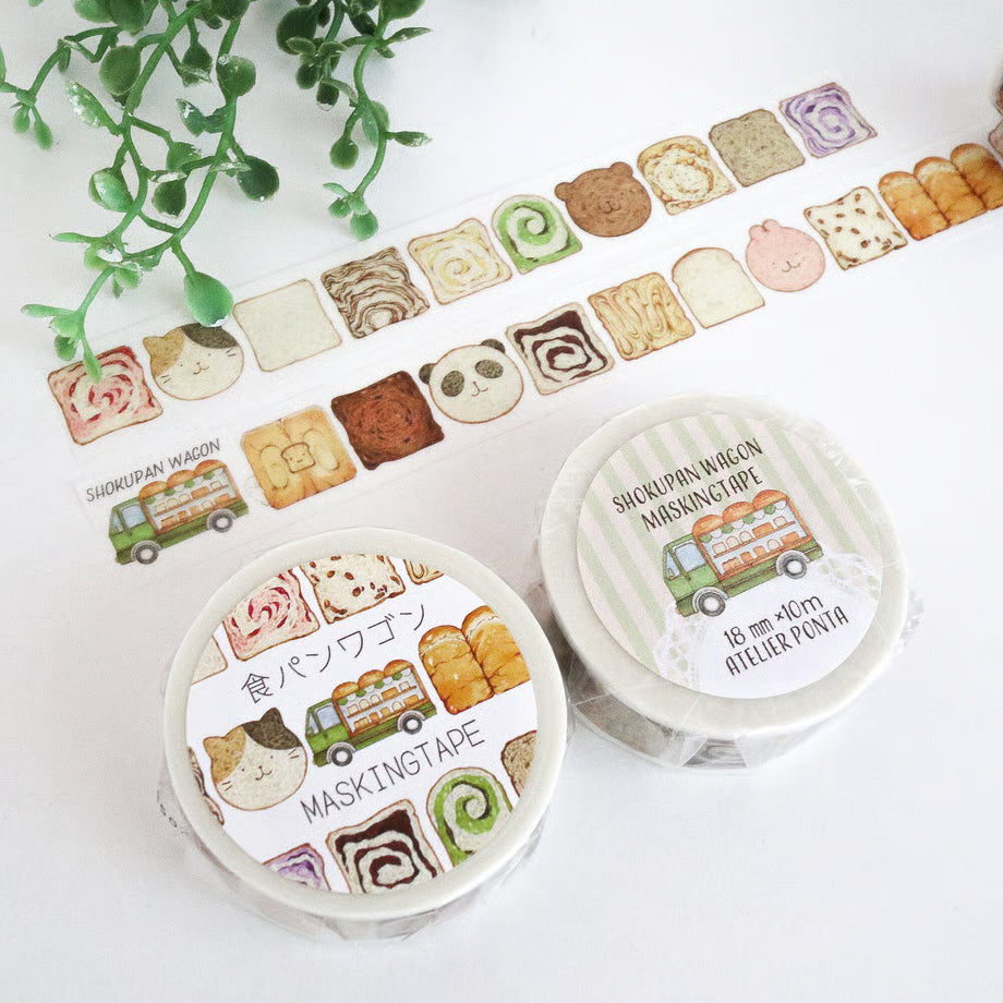 Two rolls of decorative tape with bread-themed designs on a white surface.