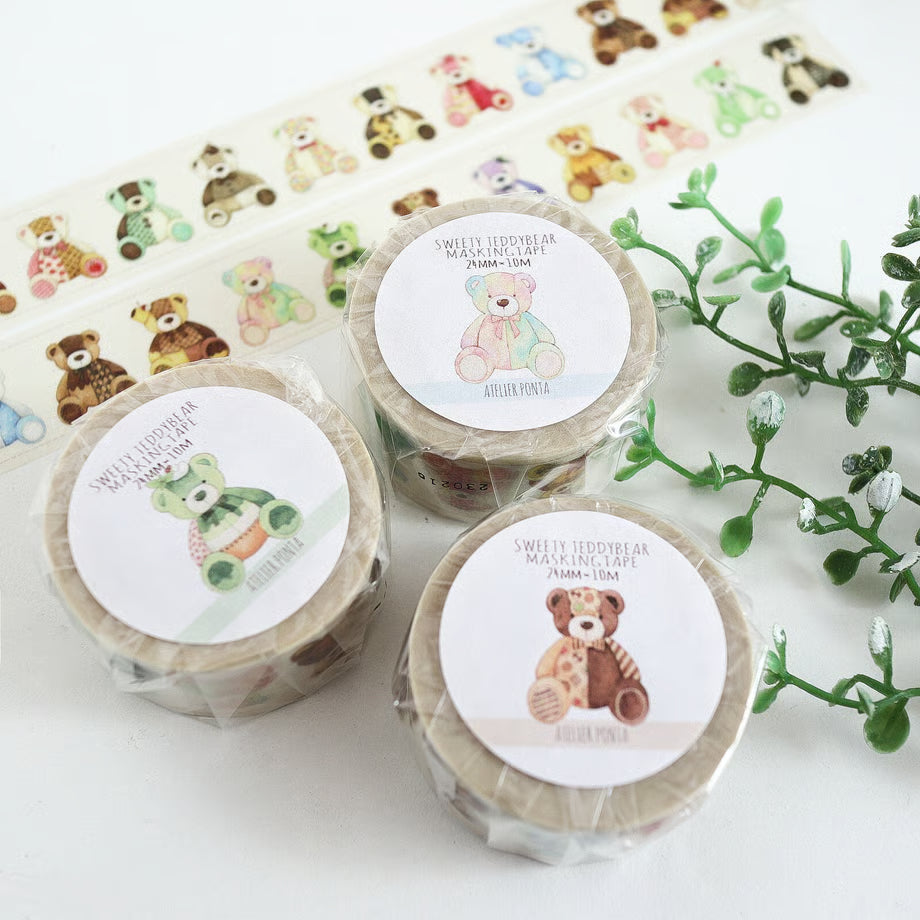 Three rolls of decorative tape with teddy bear designs on a white background