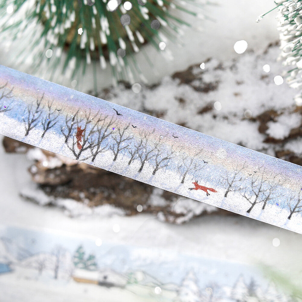 Decorative tape with winter scene design featuring trees and a fox, against a snowy background.