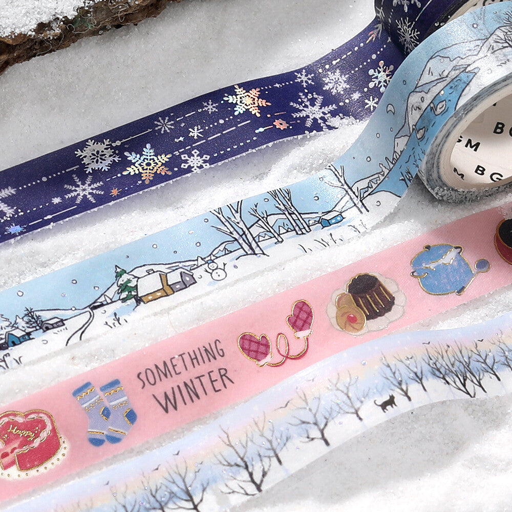 Three rolls of decorative tape with winter-themed designs on a snowy background