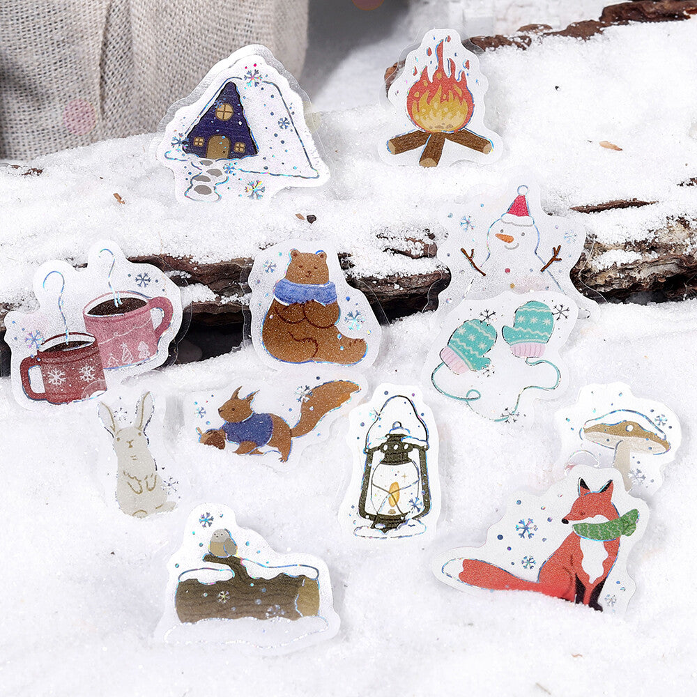 Set of winter-themed stickers on a snowy background