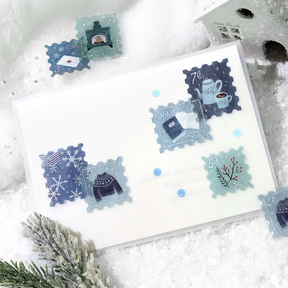 Set of decorative stamps on a white card with snowflake and winter-themed designs.