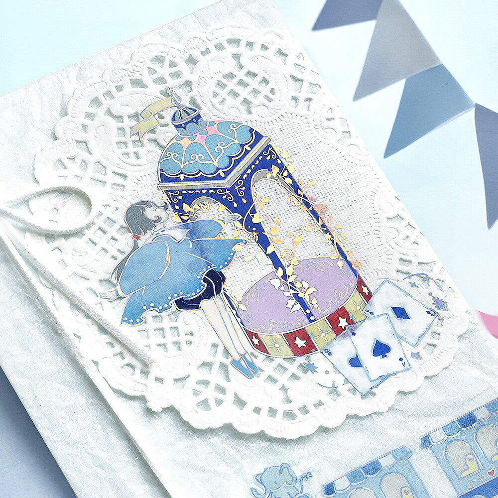 Decorative card with a colorful lantern and elephant design on a white doily.
