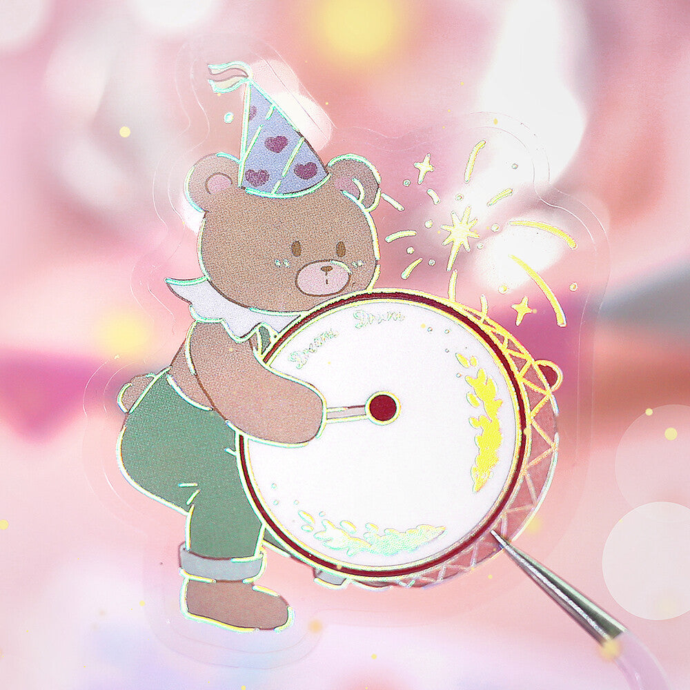Cartoon bear playing a drum with a party hat on a colorful background