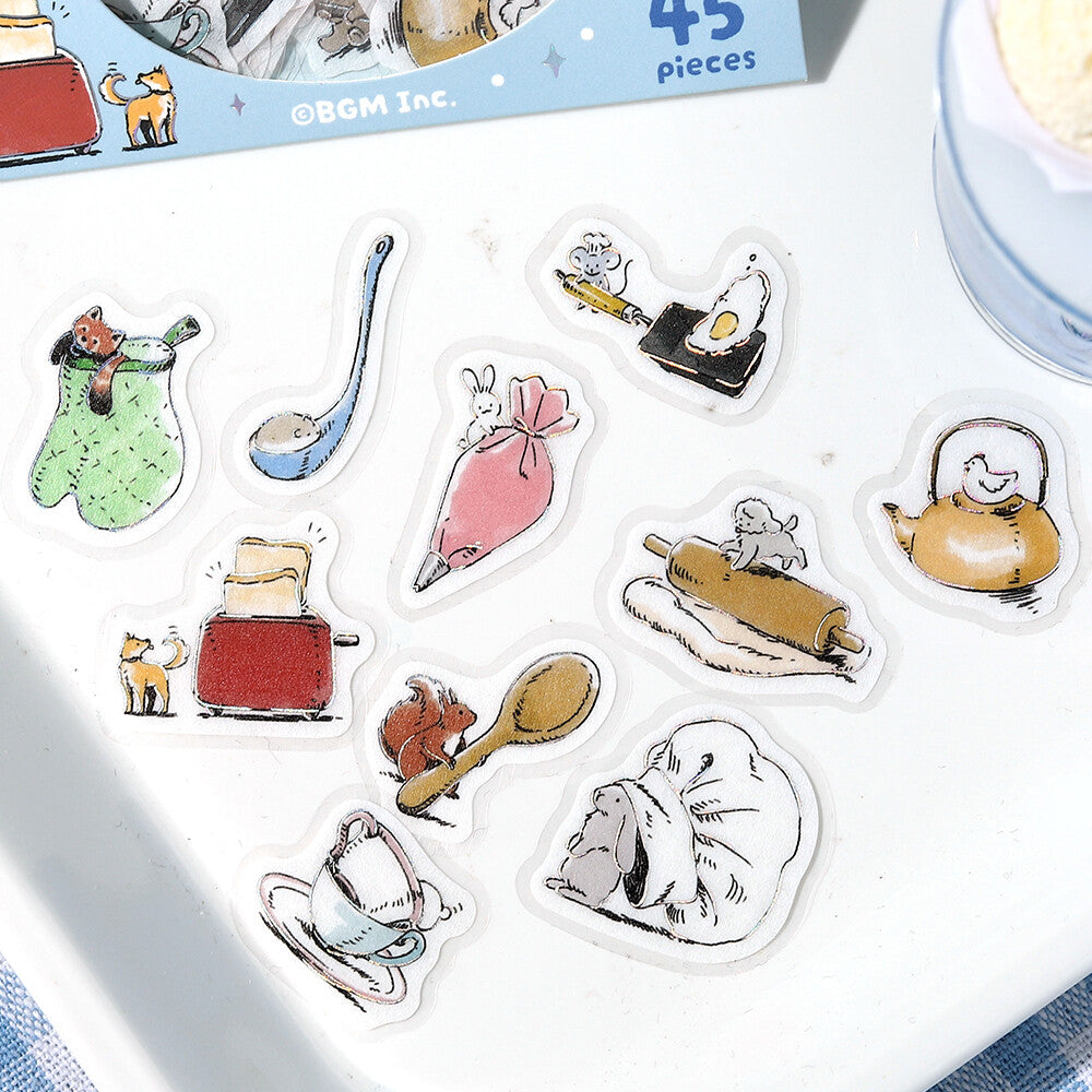Set of cartoon kitchen-themed stickers on a white surface with a box in the background.