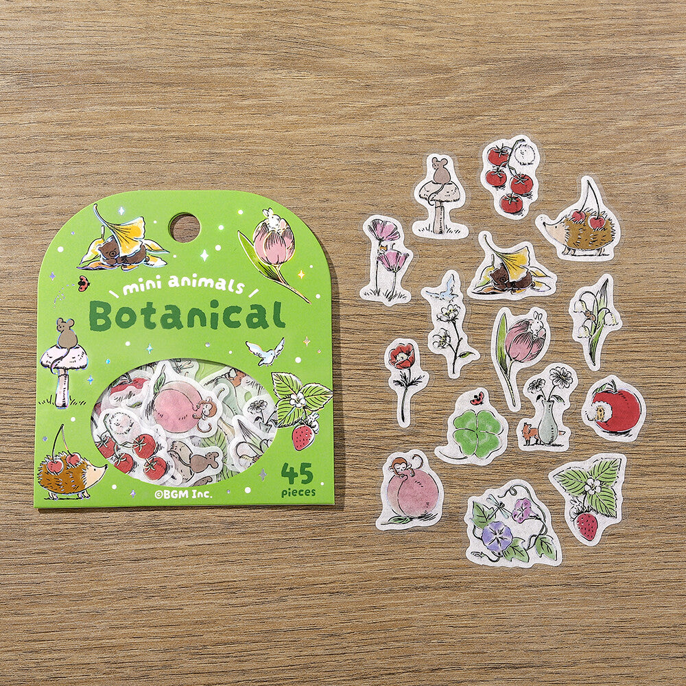 Botanical-themed stickers with a green packaging on a wooden surface