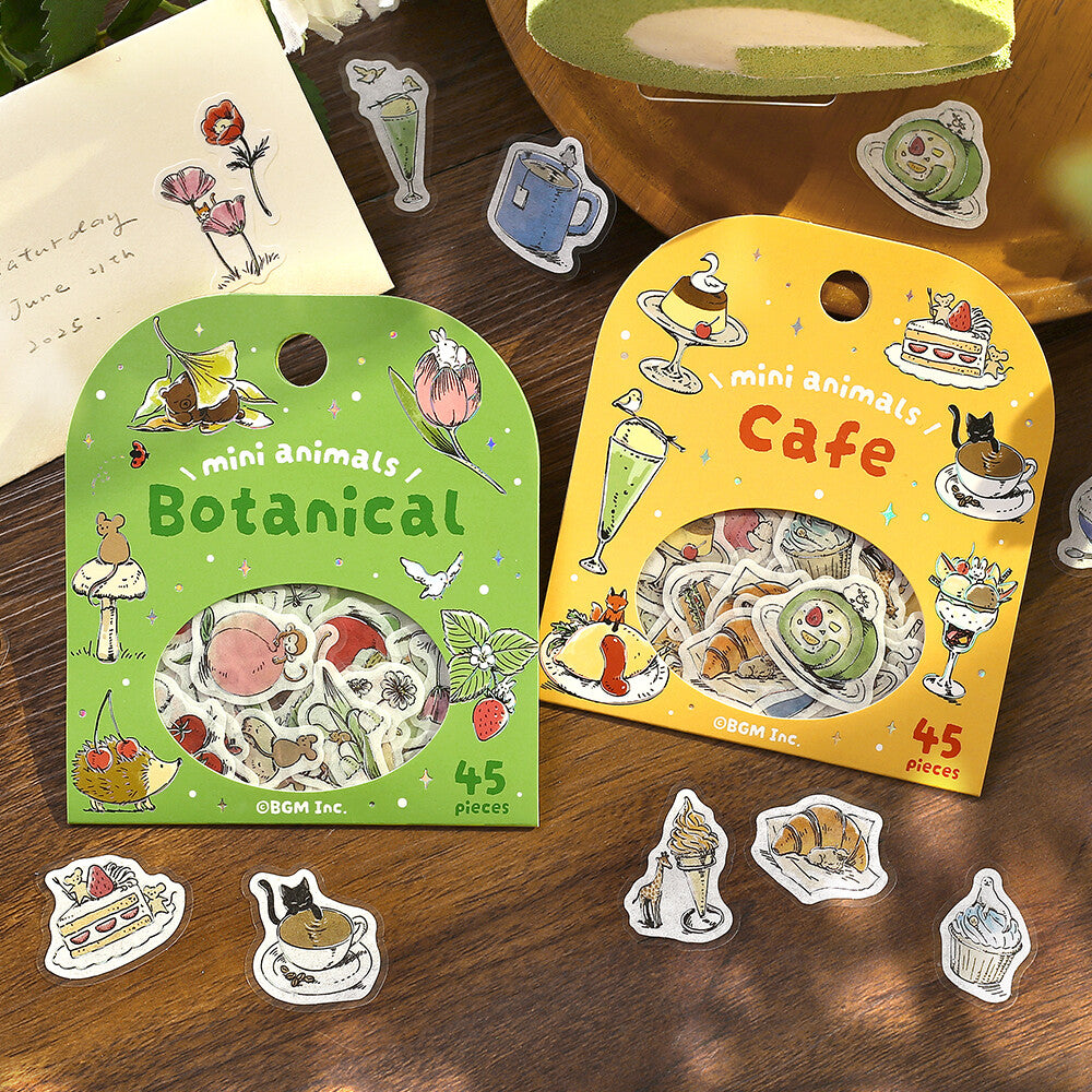 Two packages of stickers labeled 'Botanical' and 'Cafe' on a wooden surface with some stickers displayed.