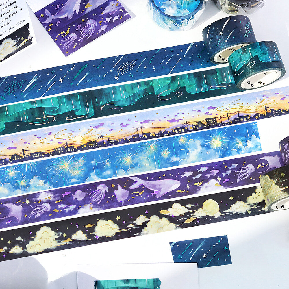 Set of decorative tapes with space-themed designs on a white surface