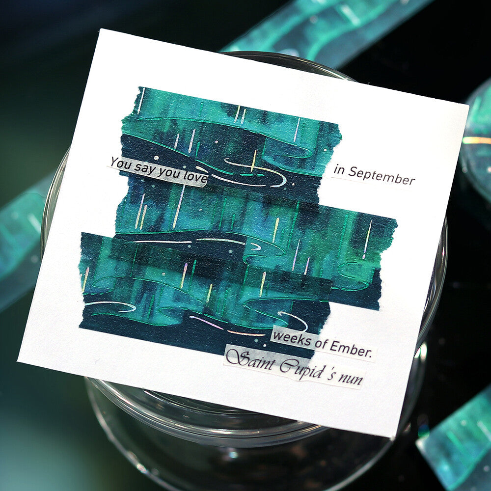 Card with artistic design and text on a glass surface