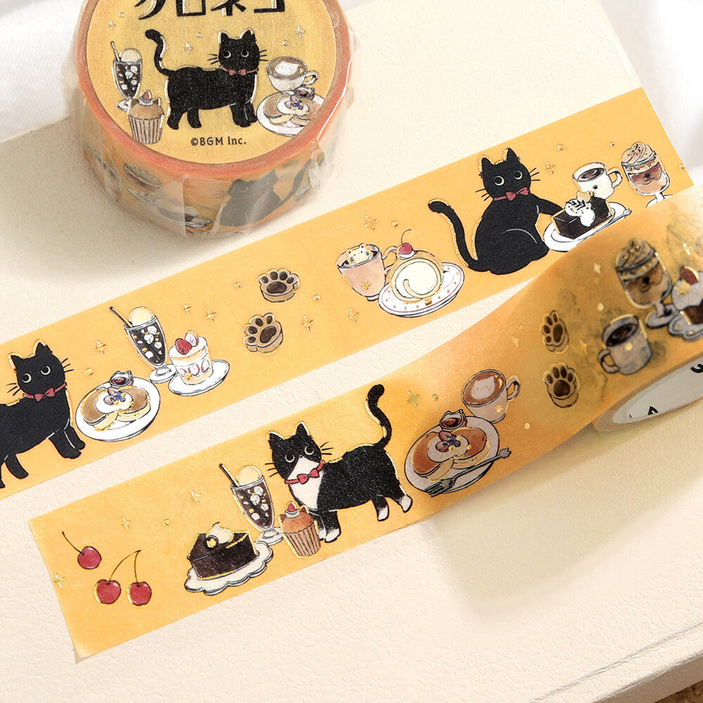 Decorative tape with black cat and dessert designs on a white surface