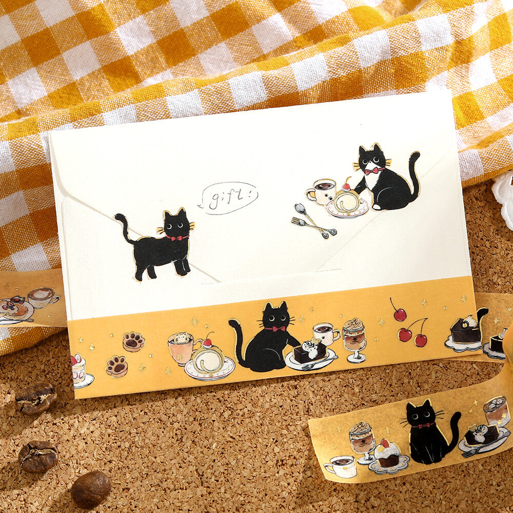 Notebook with black cat illustrations on a checkered fabric background