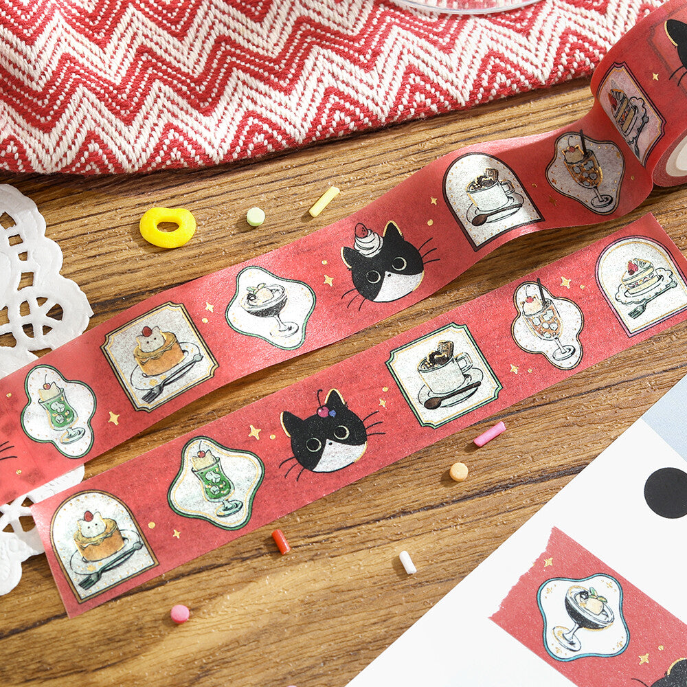 Decorative tape with cat-themed designs on a wooden surface