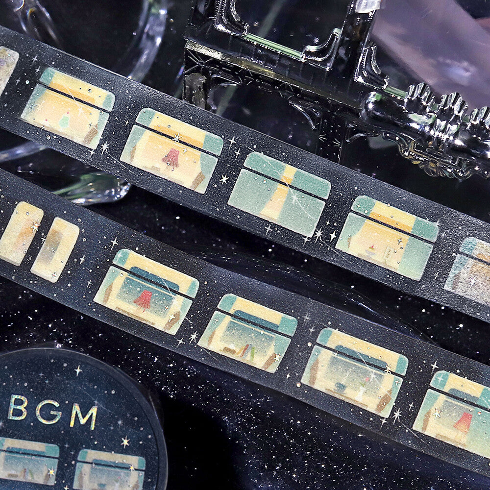 Close-up of a film reel with 'BGM' branding on a dark background