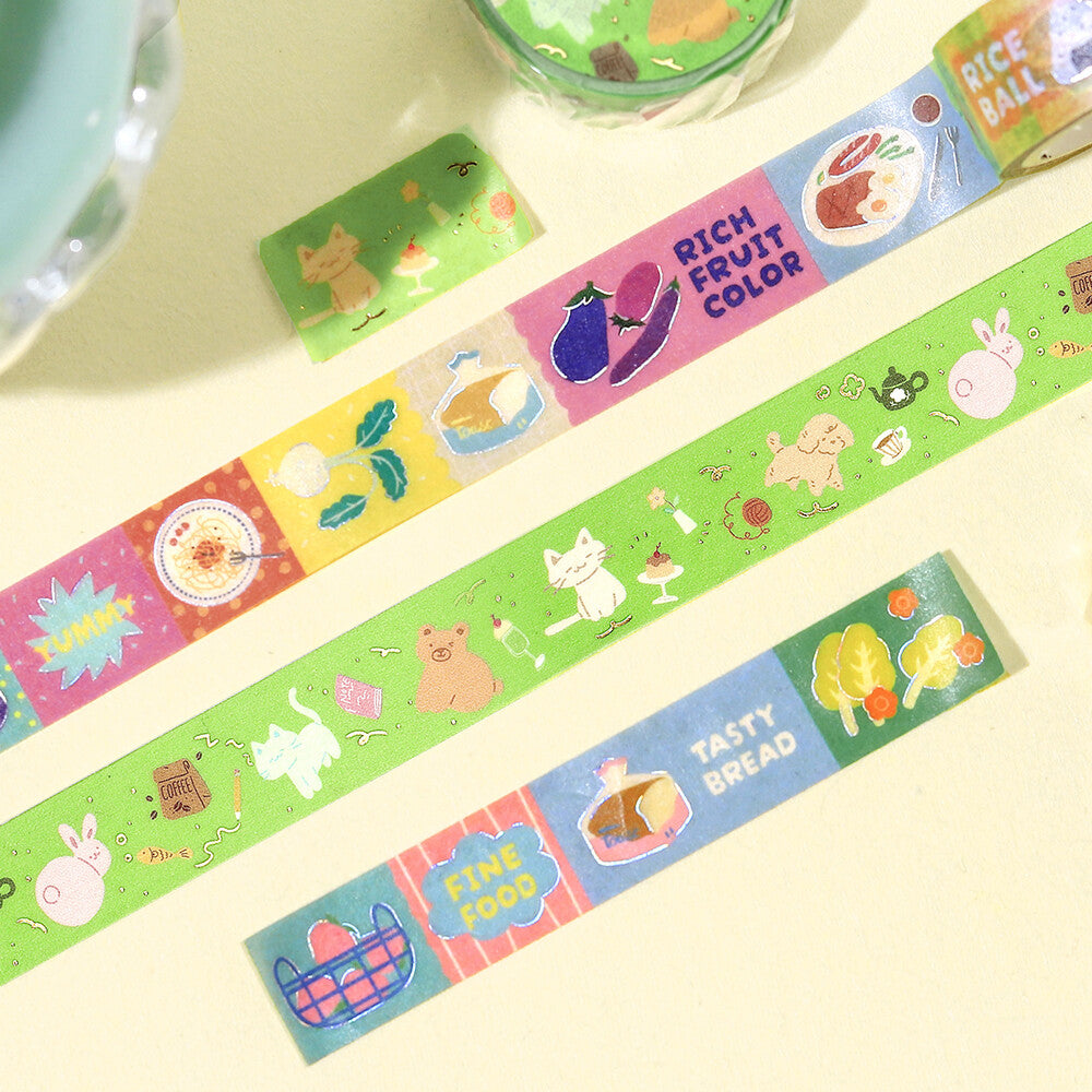 Colorful washi tape with various designs on a light yellow background