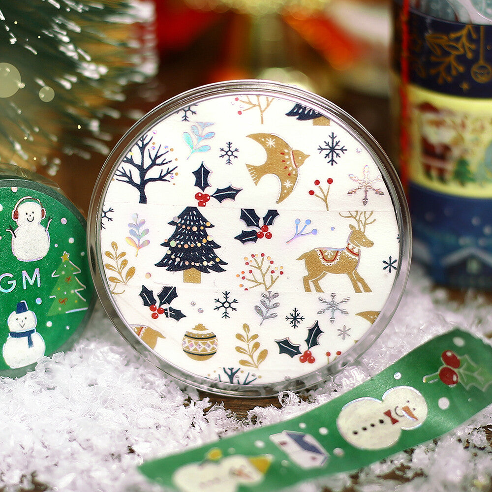 Decorative round washi tape with Christmas-themed design on a snowy surface