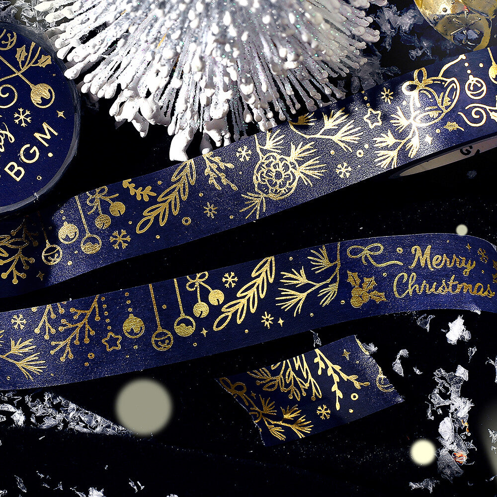 Decorative washi tape with gold Christmas designs on a black background