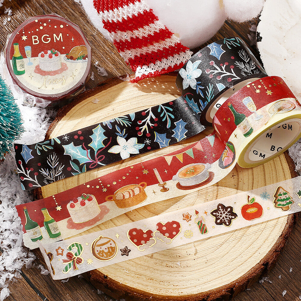 Decorative washi tapes with festive designs on a wooden surface
