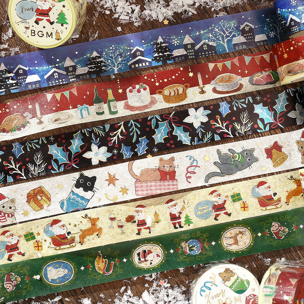 Collection of decorative washi tapes with festive designs on a wooden surface.