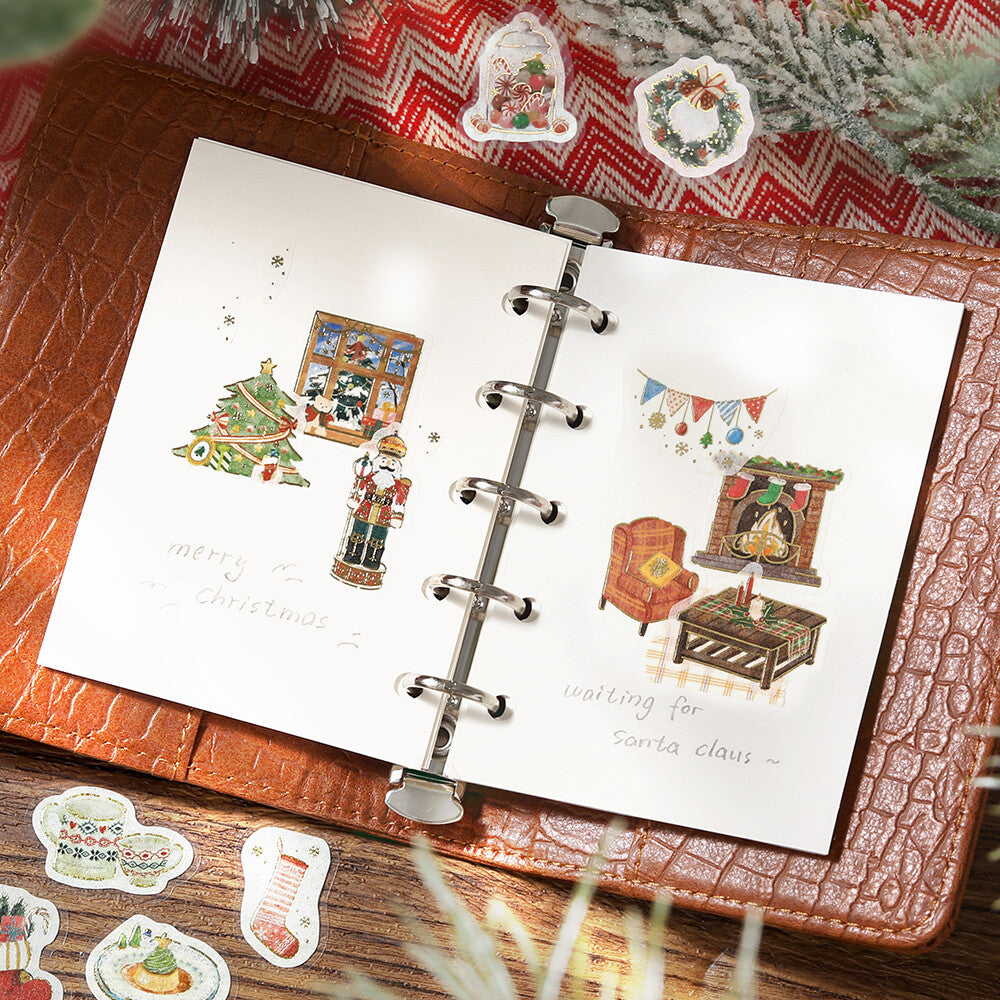 Open book with Christmas-themed illustrations on a textured surface with decorative elements.