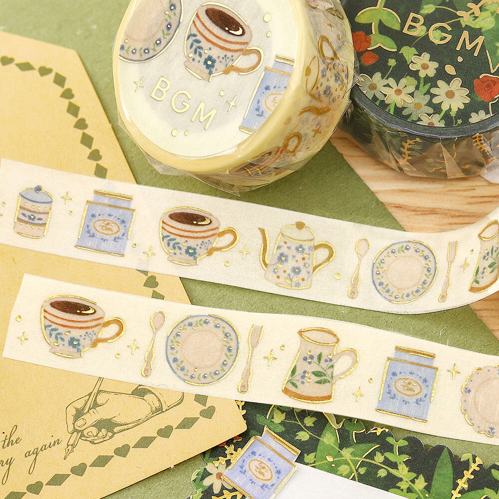 Decorative tape with tea-themed designs on a green surface