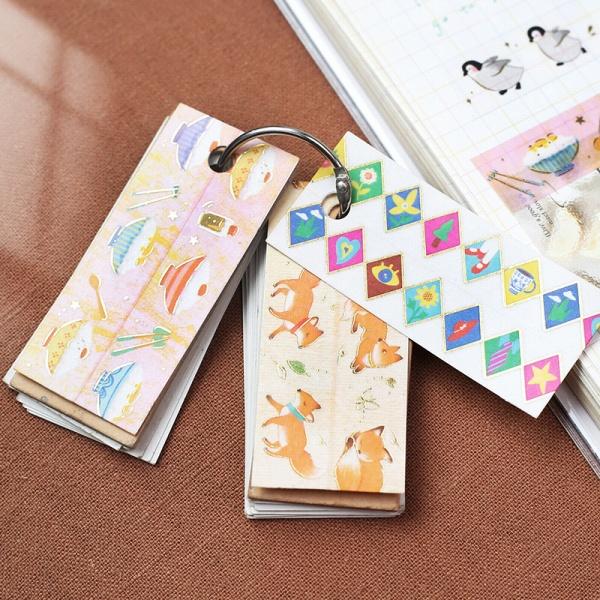 Set of colorful bookmarks with various designs on a brown surface