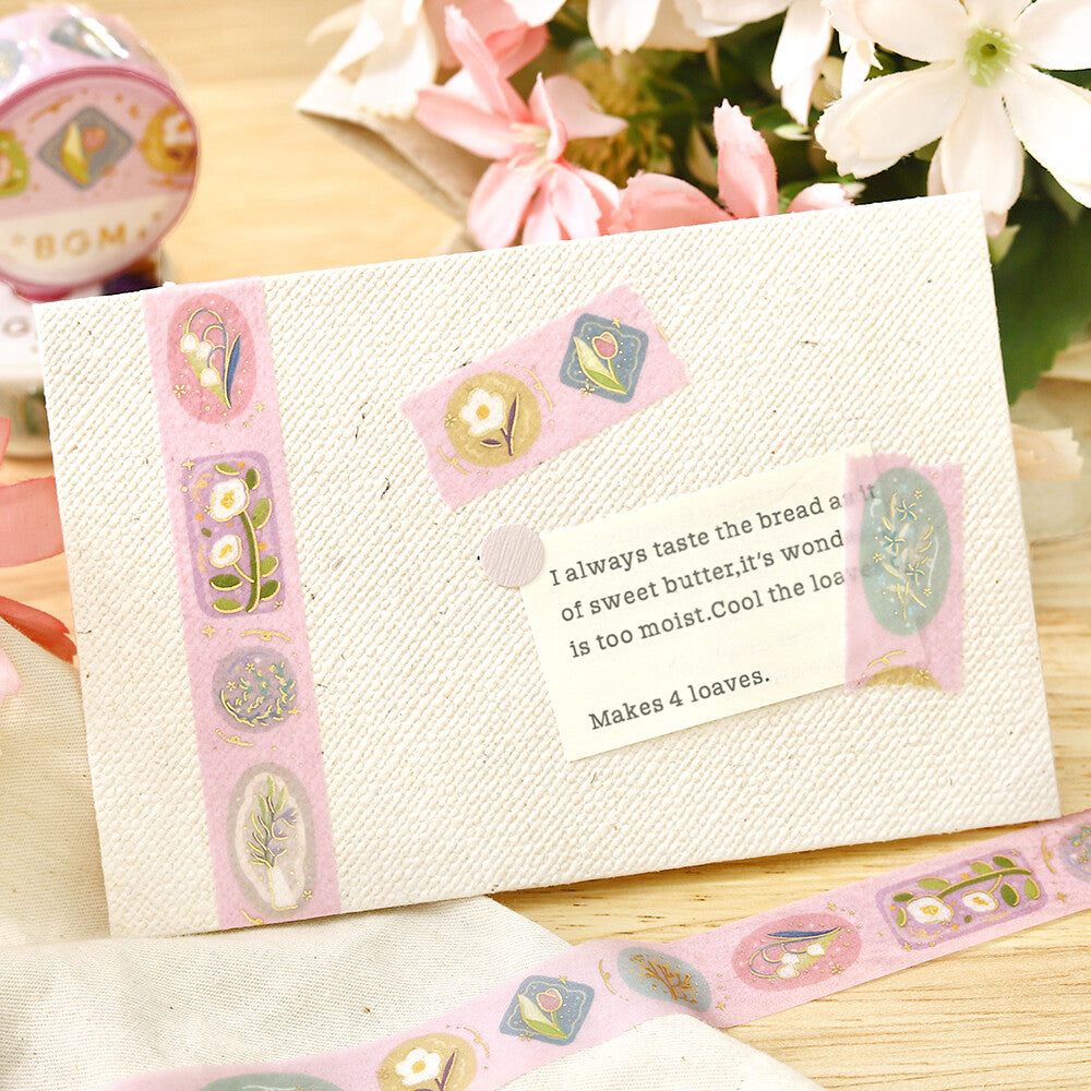 Decorative baking recipe card with decorative border on a wooden surface with flowers in the background