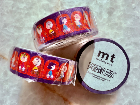 Two rolls of mt masking tape with Peanuts character design on a marble surface