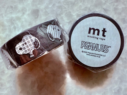 Two rolls of mt masking tape with Peanuts design on a textured surface