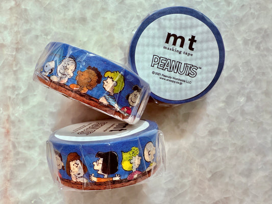 Two rolls of mt masking tape with Peanuts character design on a textured surface