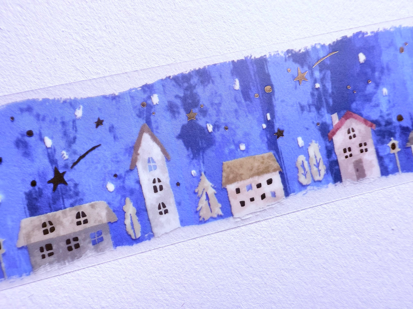 Decorative border with houses and stars on a blue background