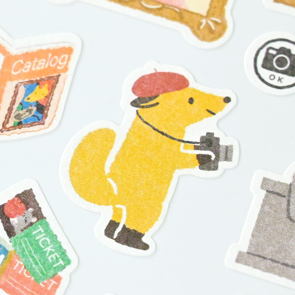 Sticker of a yellow dog with a camera on a light gray background