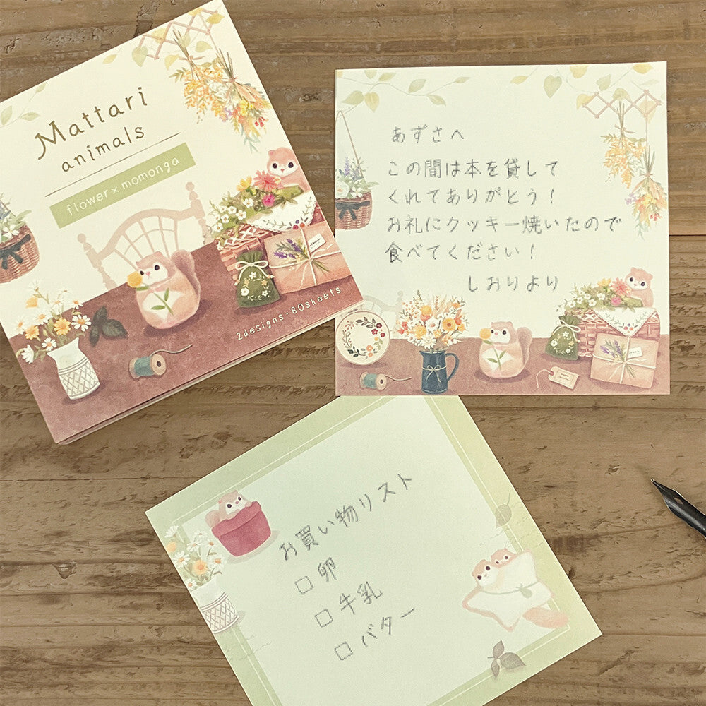 Three stationery items with cute animal illustrations on a wooden surface