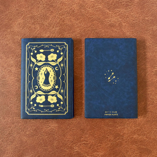 2 Blue plastic covered notebook with gold foil design on a leather background