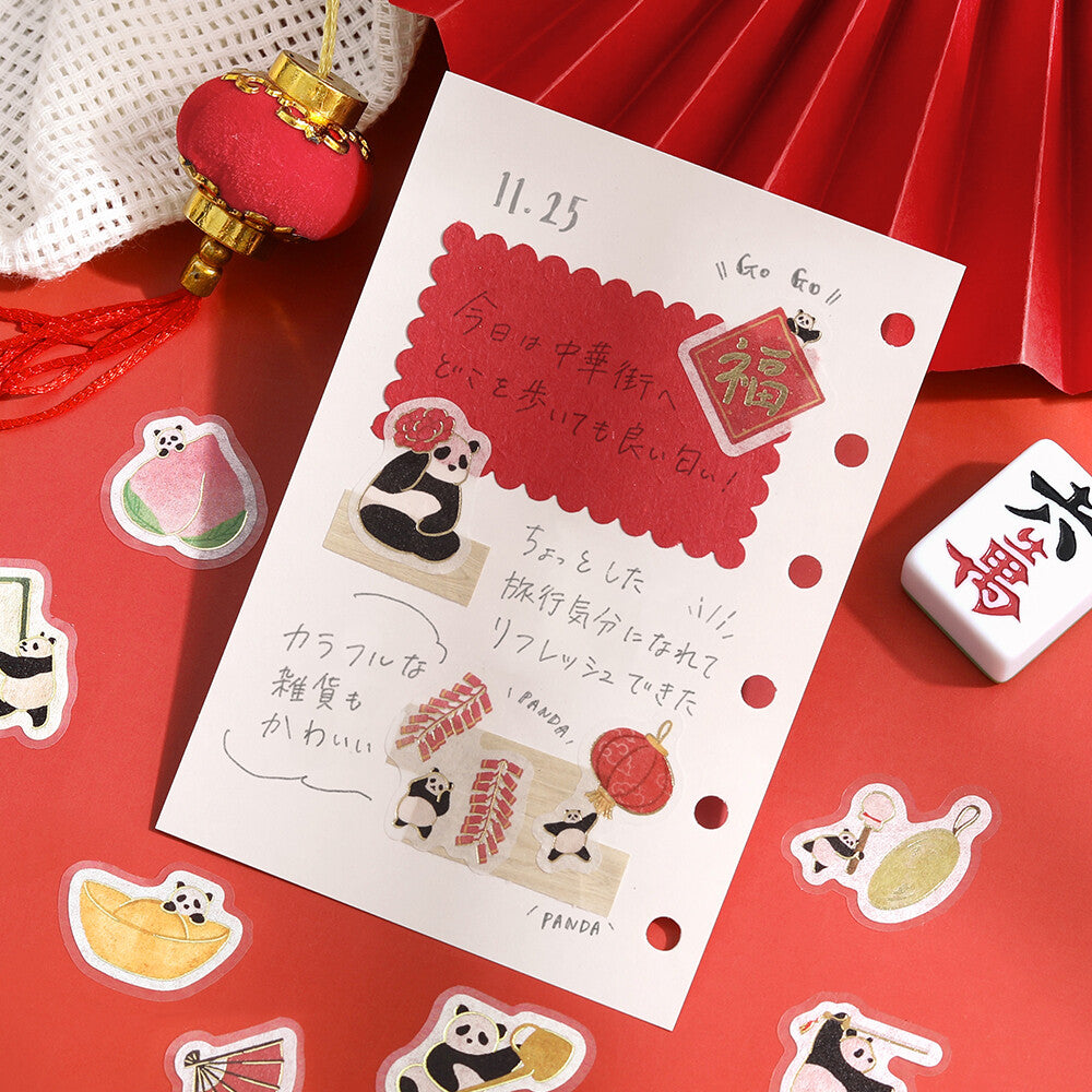 Sheet of stickers with panda designs on a red background