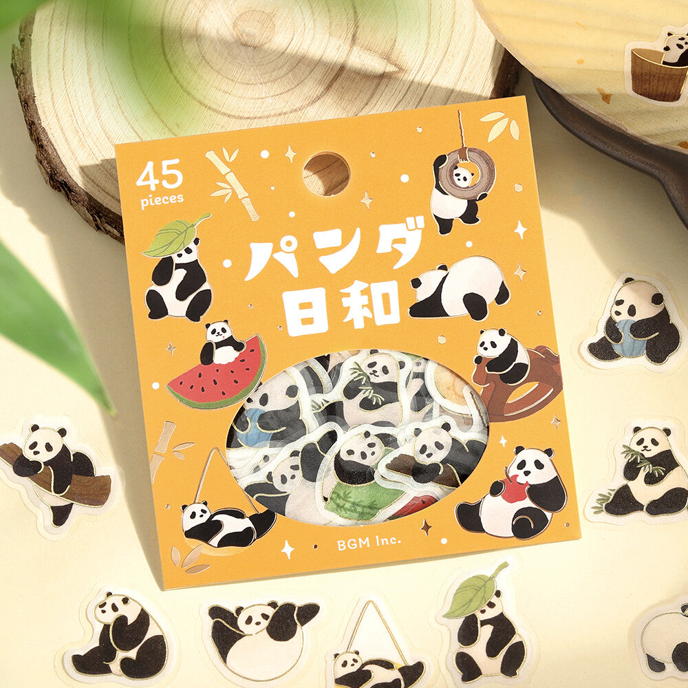 Packaging of panda-themed stickers with panda illustrations on a wooden surface