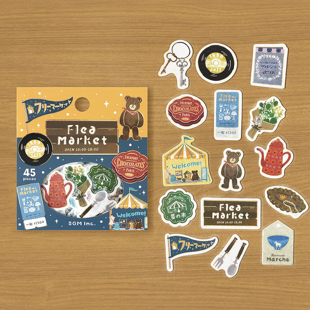Sticker set with 'Flea Market' theme on a wooden surface