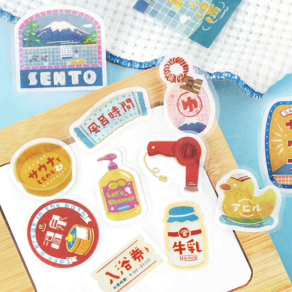 Set of colorful stickers with various designs on a wooden surface