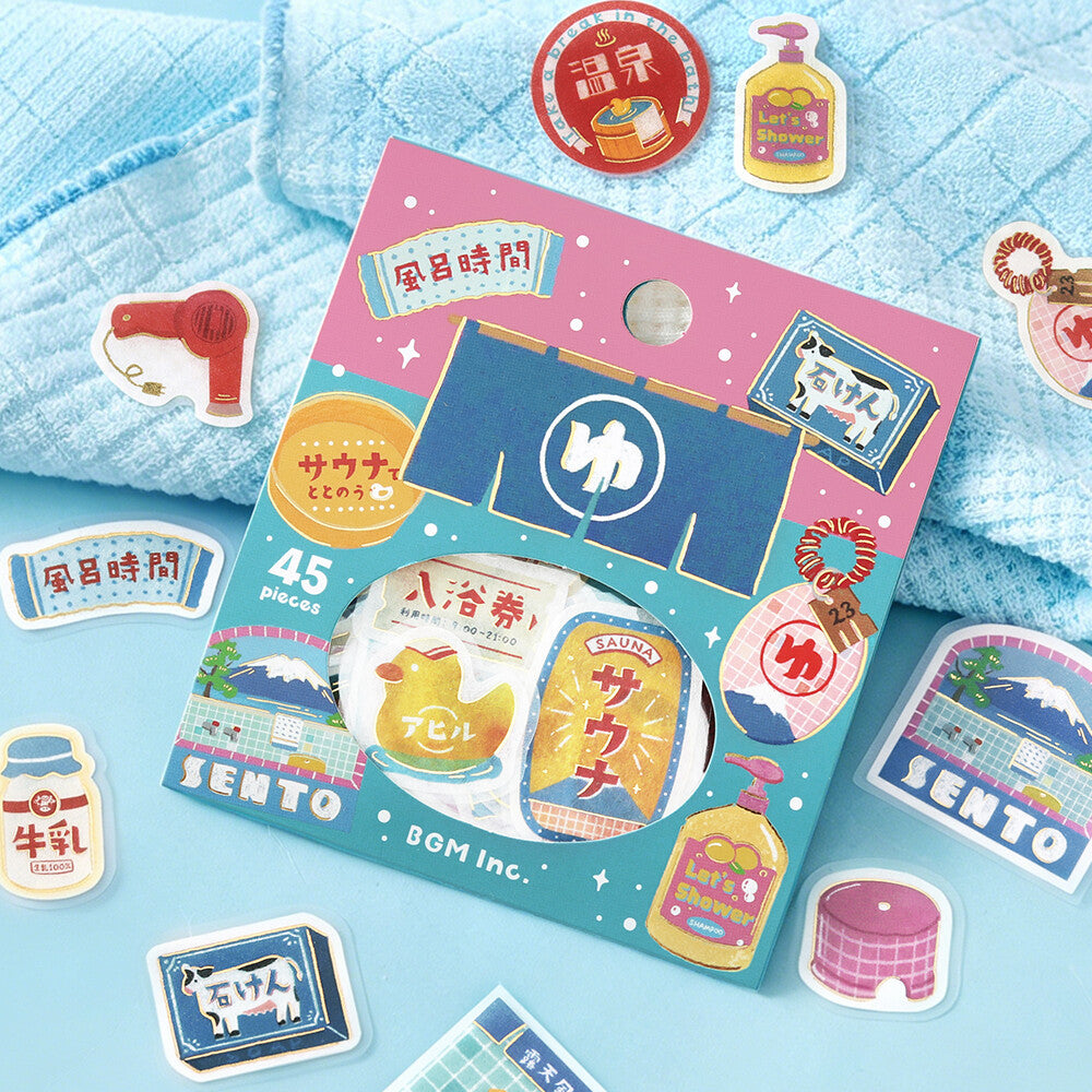 A colorful Sento BGM Inc. 45-piece sticker set displayed on a light blue textured towel with additional loose stickers scattered around it.