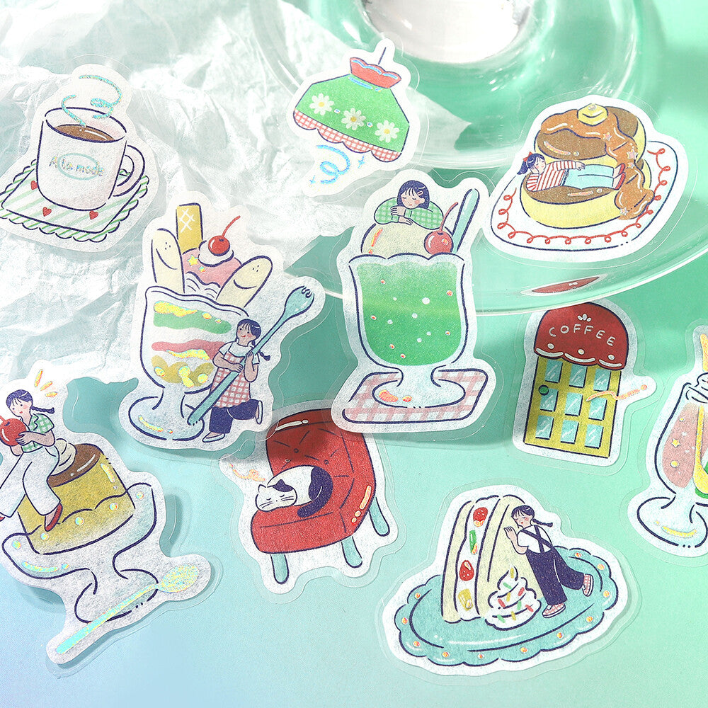 A set of cute, illustrated die-cut stickers arranged on a light mint green surface. The stickers feature whimsical drawings of desserts, drinks, a coffee shop, and characters in cozy settings.