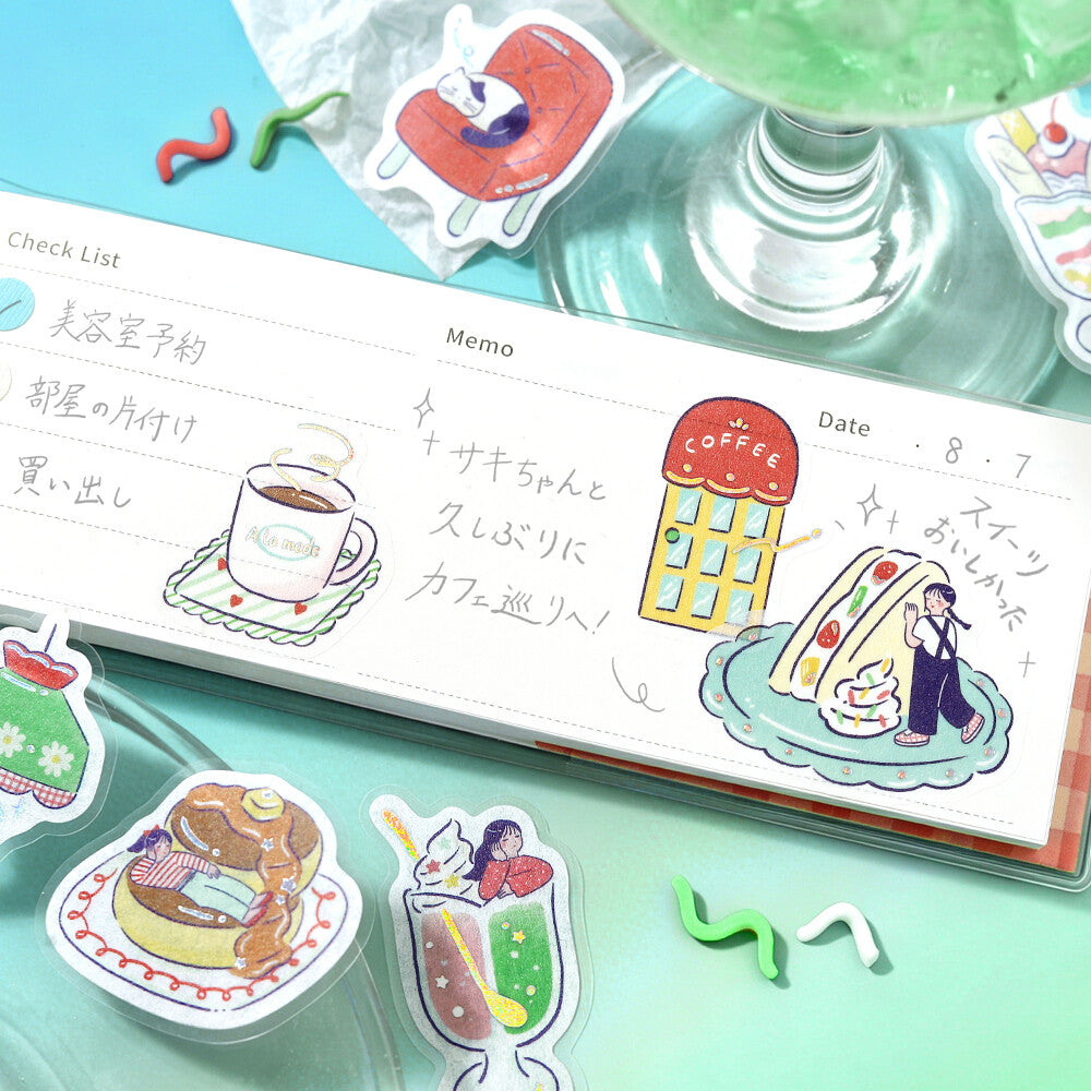 A close-up of a white check list tape or memo strip printed with cute coffee-themed illustrations, surrounded by matching die-cut stickers on a mint green surface.