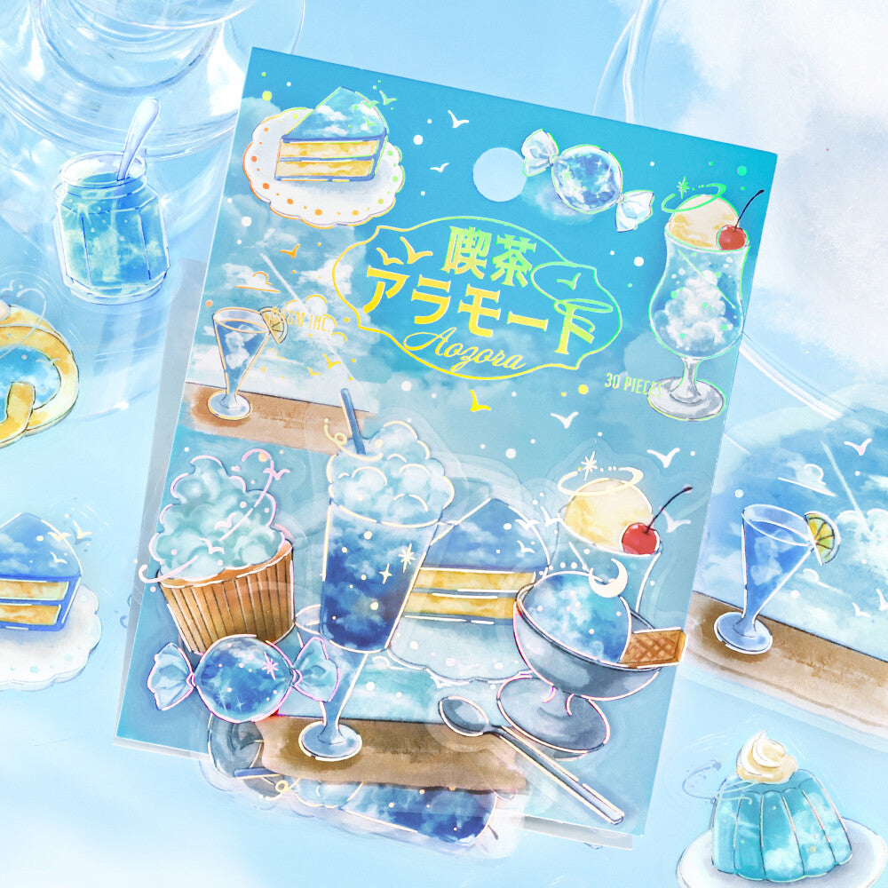 A packaged blue-themed dessert illustration card or sticker sheet with Japanese text, shown on a light pastel background with matching blue dessert illustrations around it.