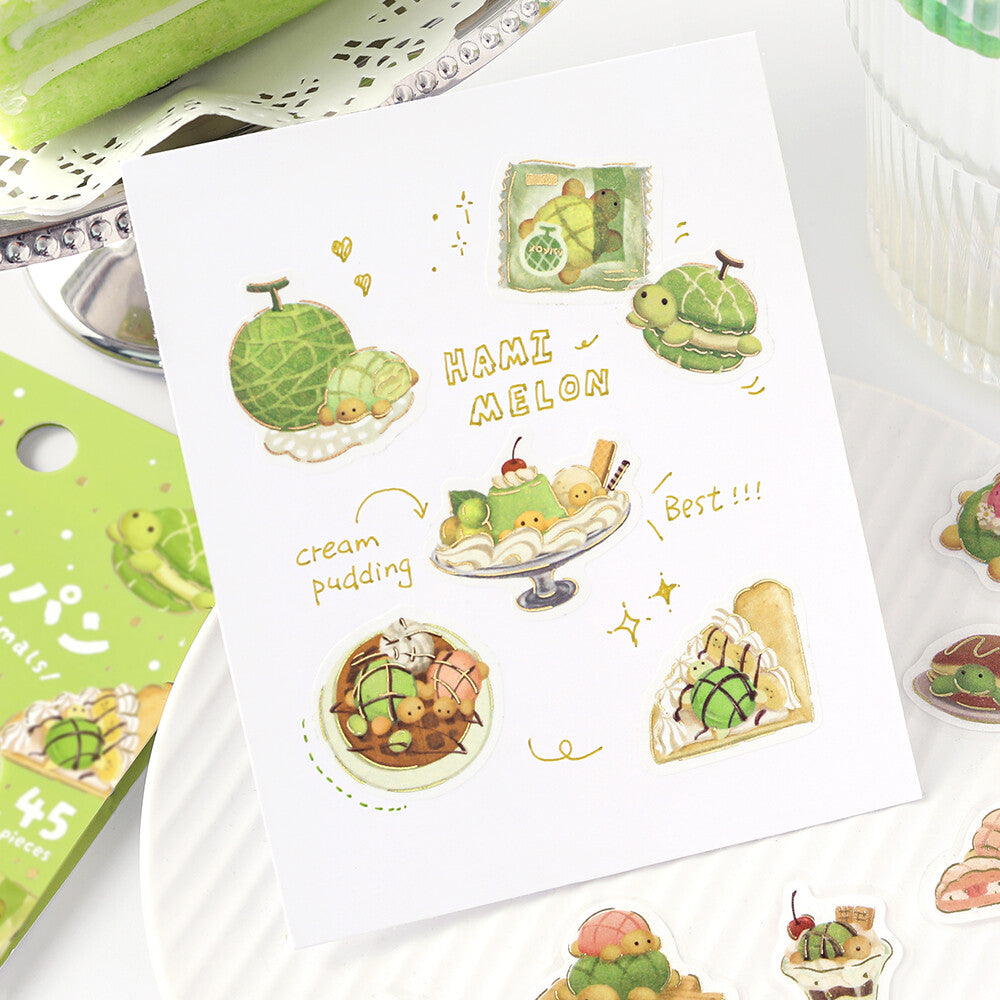 A sheet of cute watercolor-style stickers featuring hamster illustrations in food-themed designs, including a hamster melon, cream pudding, and cake slices, displayed on a white plate with other stickers around it.