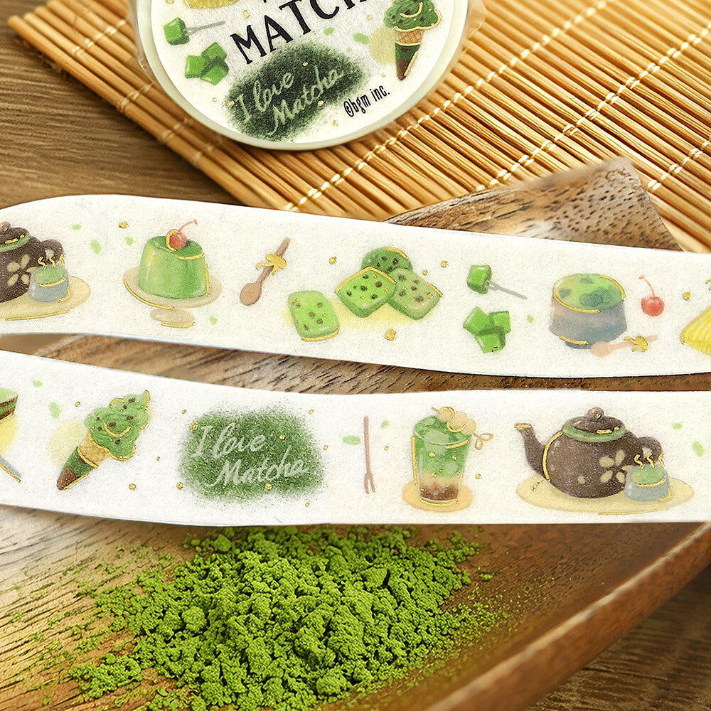 Decorative washi tape with matcha-themed designs on a wooden surface.