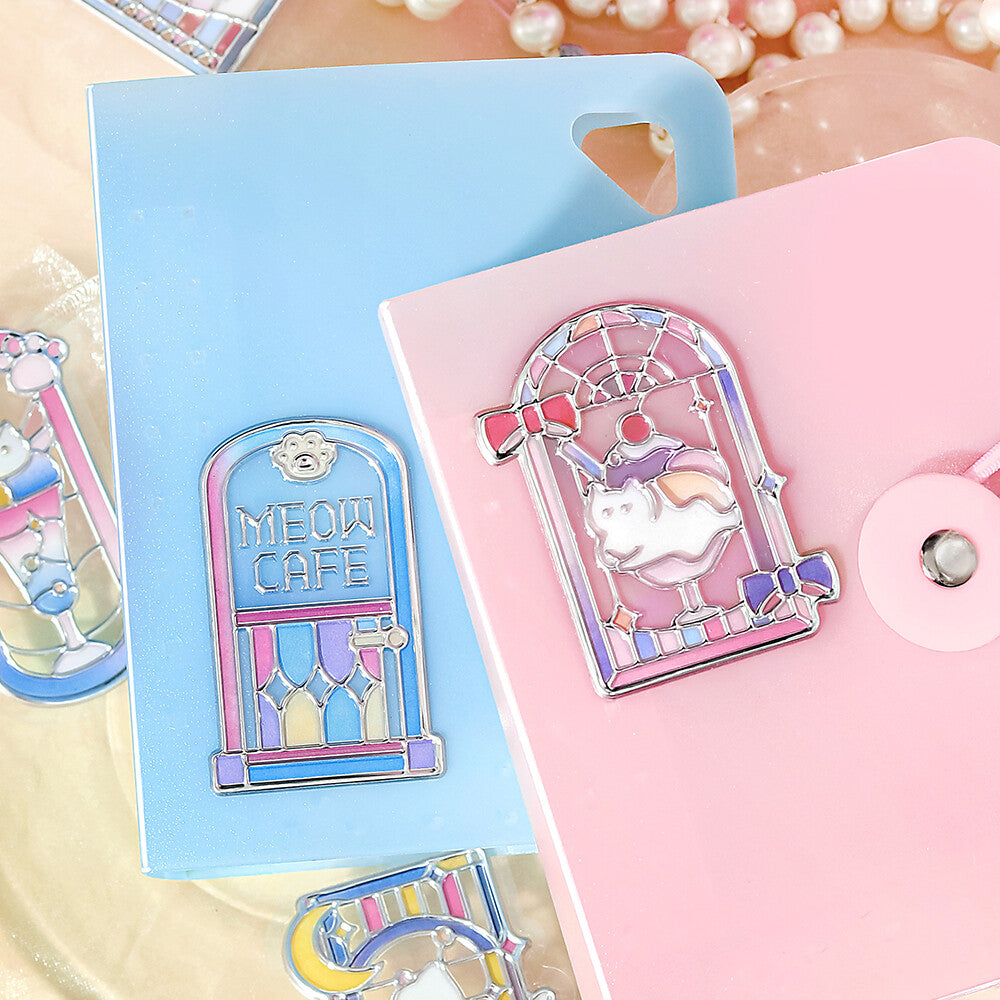 Two notebooks with BGM stickers with a pink theme with illustrations of cats sitting by a window with light yellow background