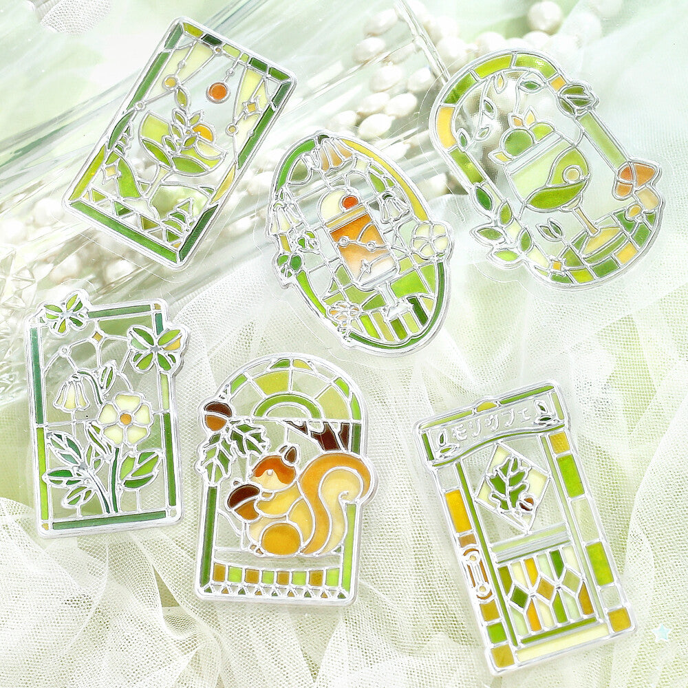 5 green themed 3D stickers inspired by the forest and stained glass by BGM on a white fabric background