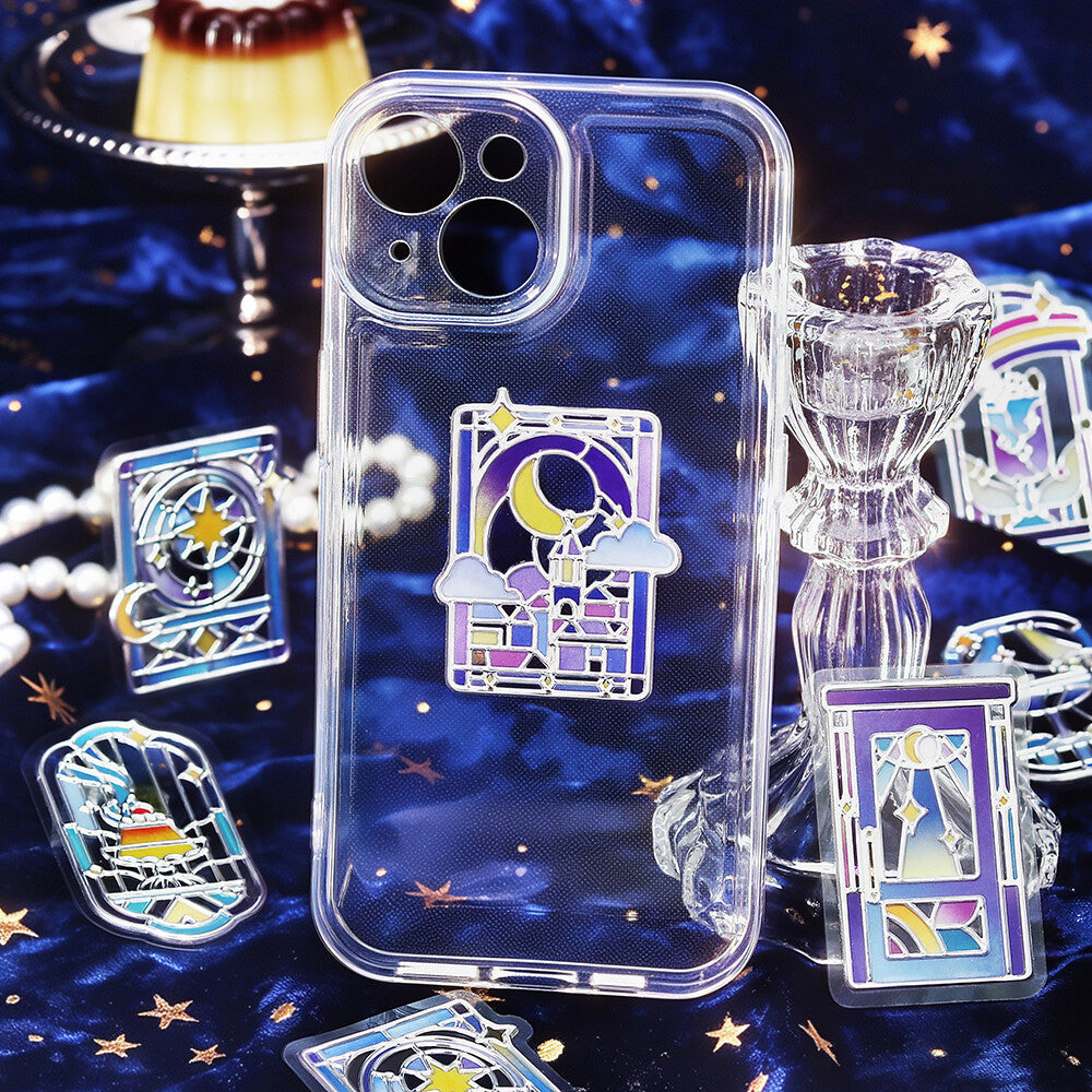Clear phone case with blue themed stickers seals with pictures of desserts and night scenes on a blue velvet background